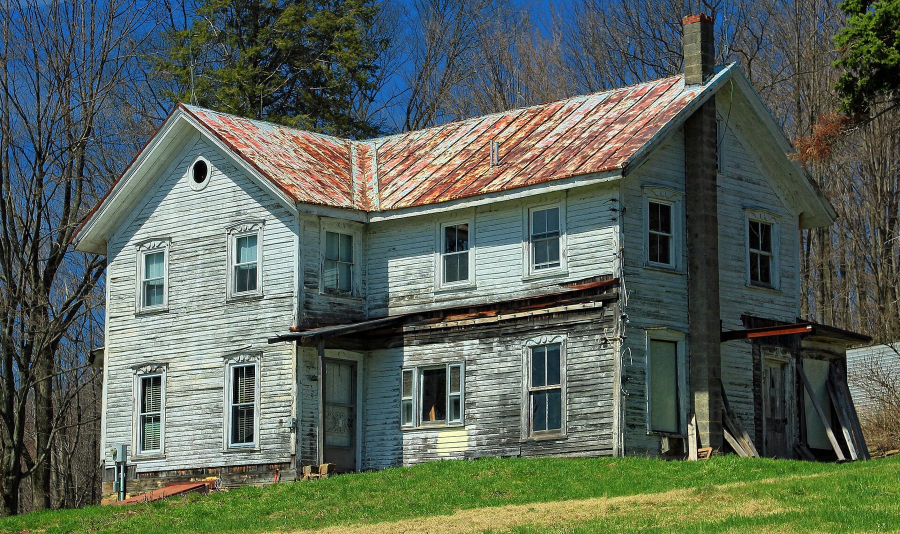 Weathered two-story farmhouse in need of repairs